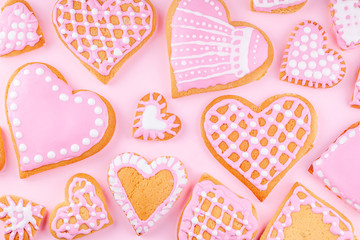 Fototapeta premium Handmade Glazed Decorated Heart Shaped Cookies on Pink Background. Concept of Happy Valentines Day. Top view