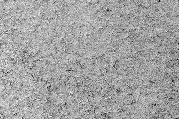 An old sheet of plywood with fragments of pressed sawdust gray.