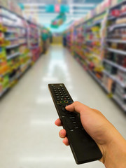 Tv remote control. supermarket in blurry for background