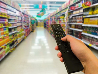 Tv remote control. supermarket in blurry for background