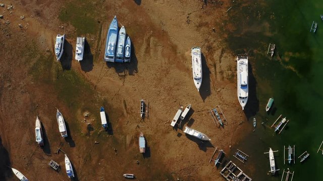 Aerial drone flight over boats aground, Bal, Indonesia, 4k