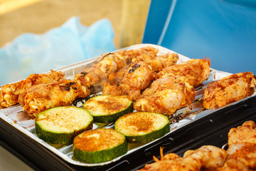 Chicken meat grilling on gas grill