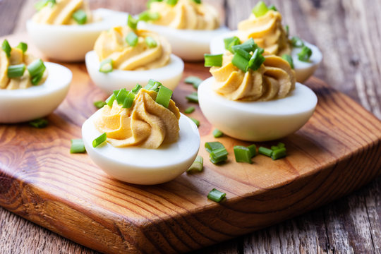 Deviled eggs on rustic wooden background