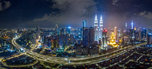 Fototapeta premium KUALA LUMPUR / Malaysia - 01 JAN 2020: Panorama aerial night view of downtown Kuala Lumpur Malaysia district skyline. logo removed