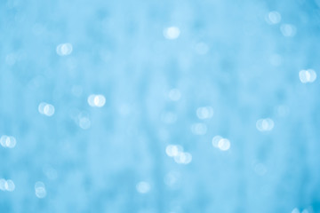 Blurred light blue bubbles bokeh abstract background.