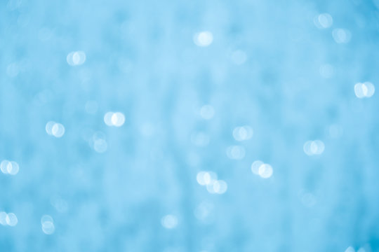 Blurred Light Blue Bubbles Bokeh Abstract Background.