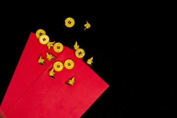 Accessories Red paper card or Red Envelope Red Packet and golden coins decoration on black background with copy space for text , Happy Chinese new year or lunar new year vacation concept.