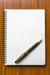 close up opening note paper and pen on wood texture background with copy space