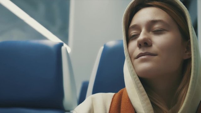 Portrait of attractive smiling girl in train and smiling transport young slow motion