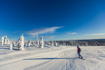 Beautiful vibrant aerial winter mountain view of ski resort, sunny winter day with slope, piste and...