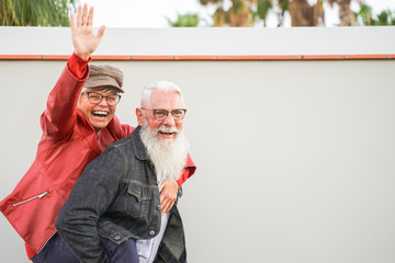 Retired couple playing to be young. Elderly couple having fun. Best elderly friends laughing at the camera. Retired and Young concept – Image