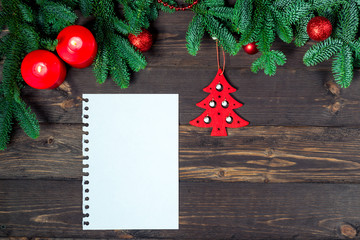Fototapeta na wymiar Notebook for writing greetings, New Year decorations top view greeting card closeup