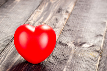 red heart on a wooden dark table close-up