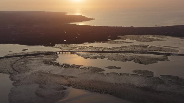 Aerial drone flight over bridge at Benoa Bay, Bali, Indonesia, 4k