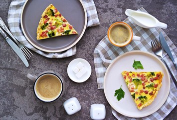 Open savory shortcrust pastry pie with ham, broccoli and egg filling on a gray concrete background. Breakfast for two on Valentine's Day. Savory pies. Top view.