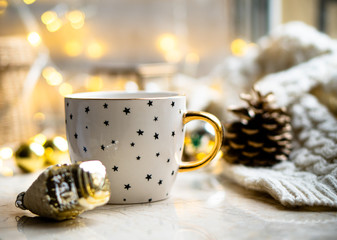 Obraz na płótnie Canvas Cozy winter holiday decoration, Christmas lights and coffee cup with decor details, real home