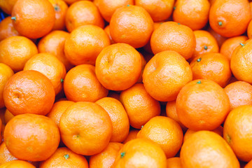Tangerines or fresh mandarin oranges fruit as background. Organic tangerine fruit for sale at market, shop. Healthy nutrition, fruit eating concept. Top view stock photo tangerine as food background.