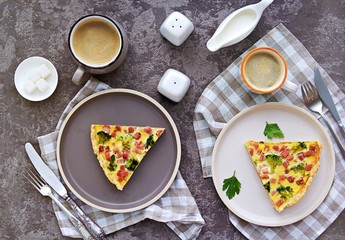 Open savory shortcrust pastry pie with ham, broccoli and egg filling on a gray concrete background. Breakfast for two on Valentine's Day. Savory pies. Top view.