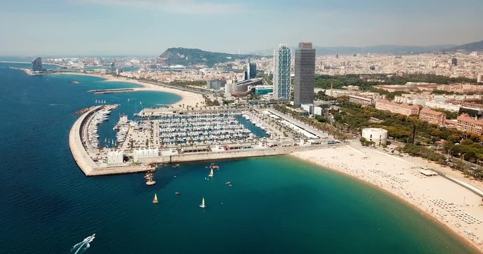 Modern cityscape of Barcelona on background with water surface of Mediterranean