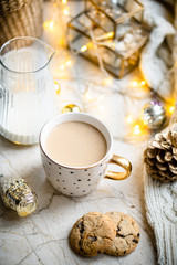 Cozy winter holiday decoration, Christmas lights and coffee cup with decor details, real home