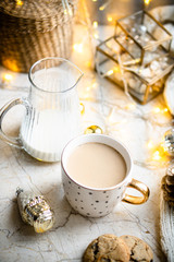 Cozy winter holiday decoration, Christmas lights and coffee cup with decor details, real home