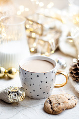 Cozy winter holiday decoration, Christmas lights and coffee cup with decor details, real home