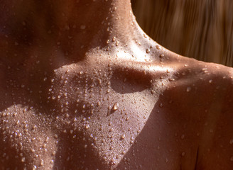 drops of sweat on tanned skin, close-up - obrazy, fototapety, plakaty