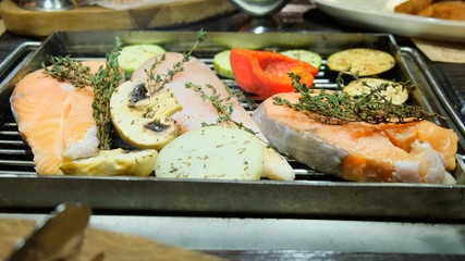 Grilled fish, grilled salmon steak, chicken, aromatic spices and grilled vegetables steak, close-up, 4k.
