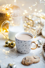 Cozy winter holiday decoration, Christmas lights and coffee cup with decor details, real home