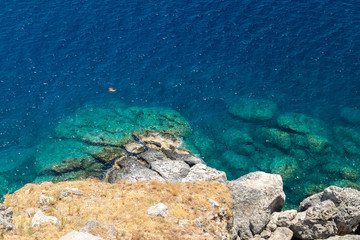 View from the acropolis on the coast with blue and turquoise water in Lindos on Rhodes island, Greece