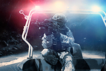 Military man in full combat ammunition is following a poacher in a boat with a flasher. Concept of...