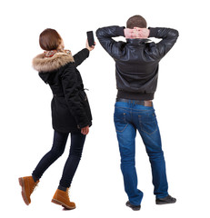 Back view of couple in winter jacket photographed on a mobile phone in winter jacket.