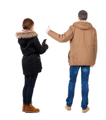 Back view of couple in winter jacket photographed on a mobile phone in winter jacket.