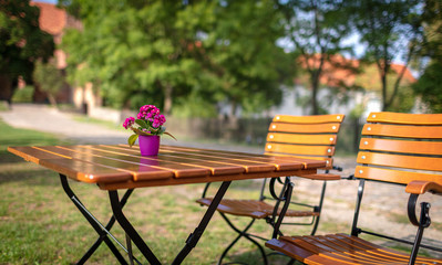 beautiful wooden garden table with a small decoration of flowers