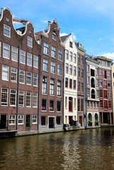 Fototapeta na wymiar Traditional dutch medieval houses built right on a canal in Amsterdam, Netherlands