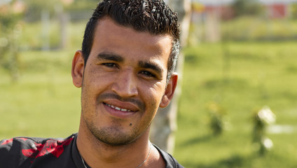 portrait of young man in the park smiling