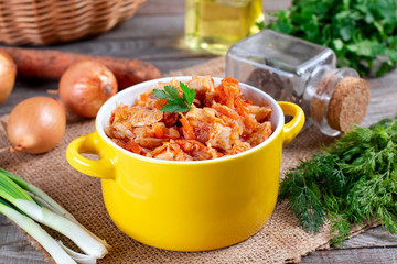 Stewed cabbage on the old wooden background