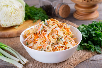 Salad with cabbage and carrots in a white plate