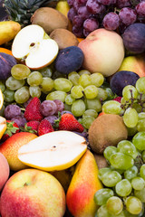 fruits background from fresh juicy fruits apples grapes, pineapple, papaya, pear, peach, figs, strawberries.