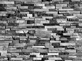 Old black brick wall texture background, stone block wall texture, rough and grunge surface as used for backdrop, wallpaper and graphic web design. Interior home new pattern designed structure