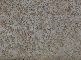 Brown background cement wall. Monolithic plaster decorative backdrop. Single layer scraped cement plaster wallpaper. Concrete exterior building structure backdrop. Silica sand cement wall plaster