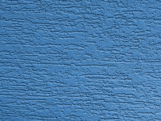 Blue background facade plaster . Monolithic plaster decorative backdrop. Single layer scraped cement plaster wallpaper. Exterior building structure backdrop. Silica sand cement wall plaster