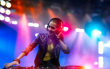 Female dj in nightclub. Mixed media