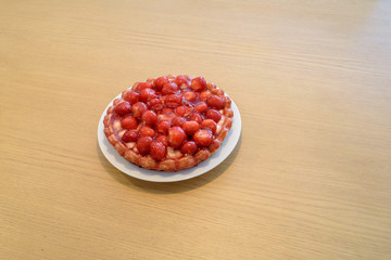 Fresh strawberry pie on wooden table