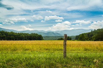 Field, fence, and mountains in Cades Cove in Great Smoky Mountains National Park