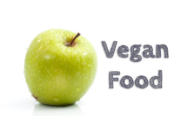 Vegan Food words written on isolated background with fresh green apple