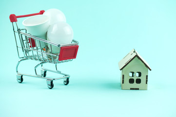 led lamps in a shopping cart near home and money, the concept of energy saving and environmental...