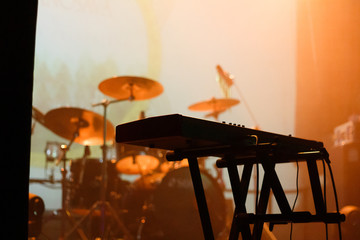 Musical instruments on the stage filled with orange light