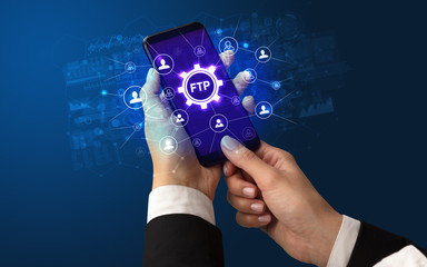 Female hand holding smartphone with FTP abbreviation, modern technology concept