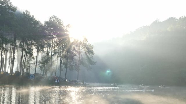 Morning atmosphere sunlight Bamboo rafting tourist over the lake Pang Ung Forestry Plantations, Maehongson Province, North of Thailand Asia. Tourist attractions relax with nature.